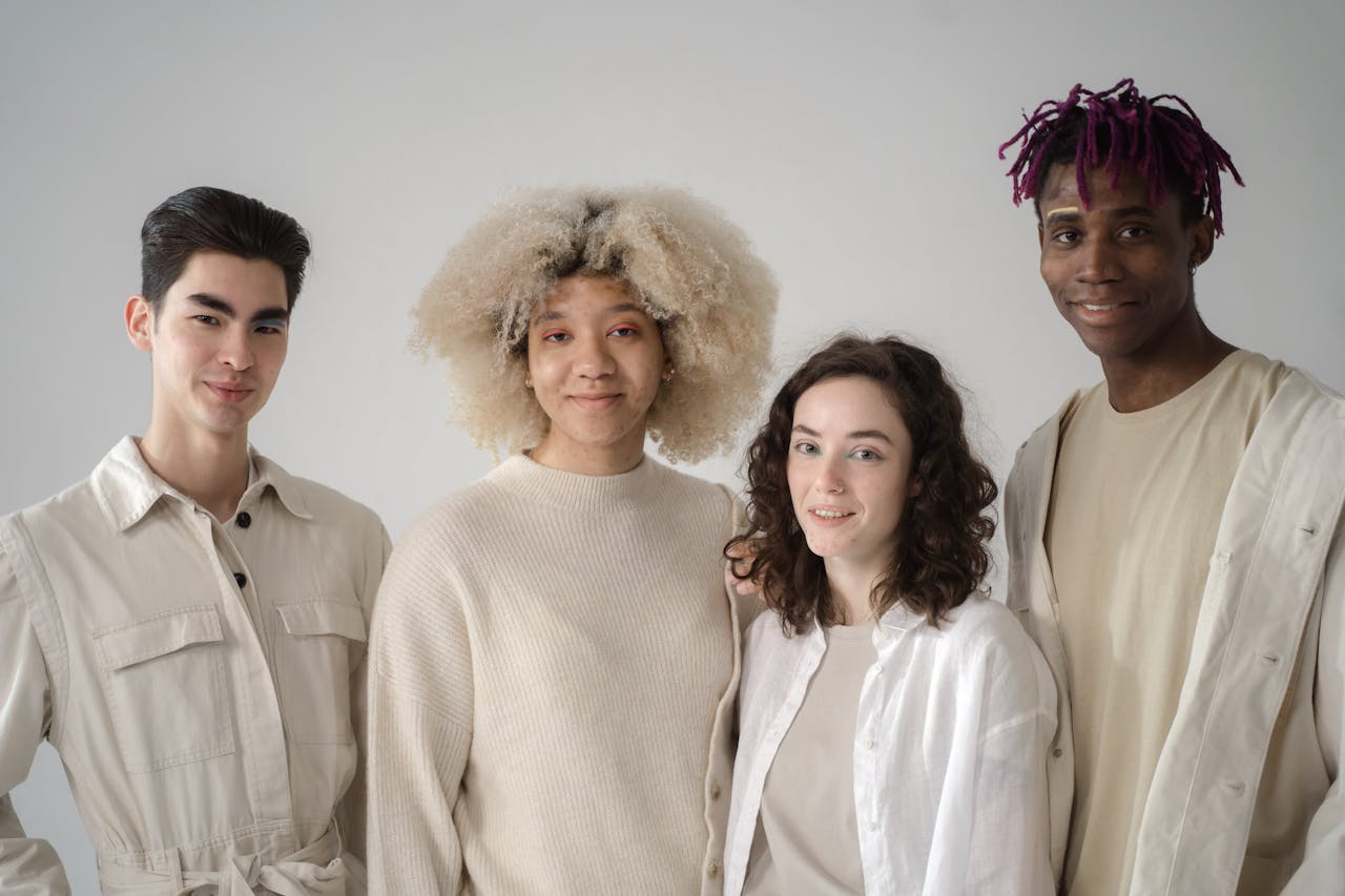Mastering the First Impression: Your intriguing post title goes here A diverse group of friends in stylish attire smiling in a studio setting.